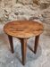 Antique round side table with oak legs and a pine top, circa 1900.