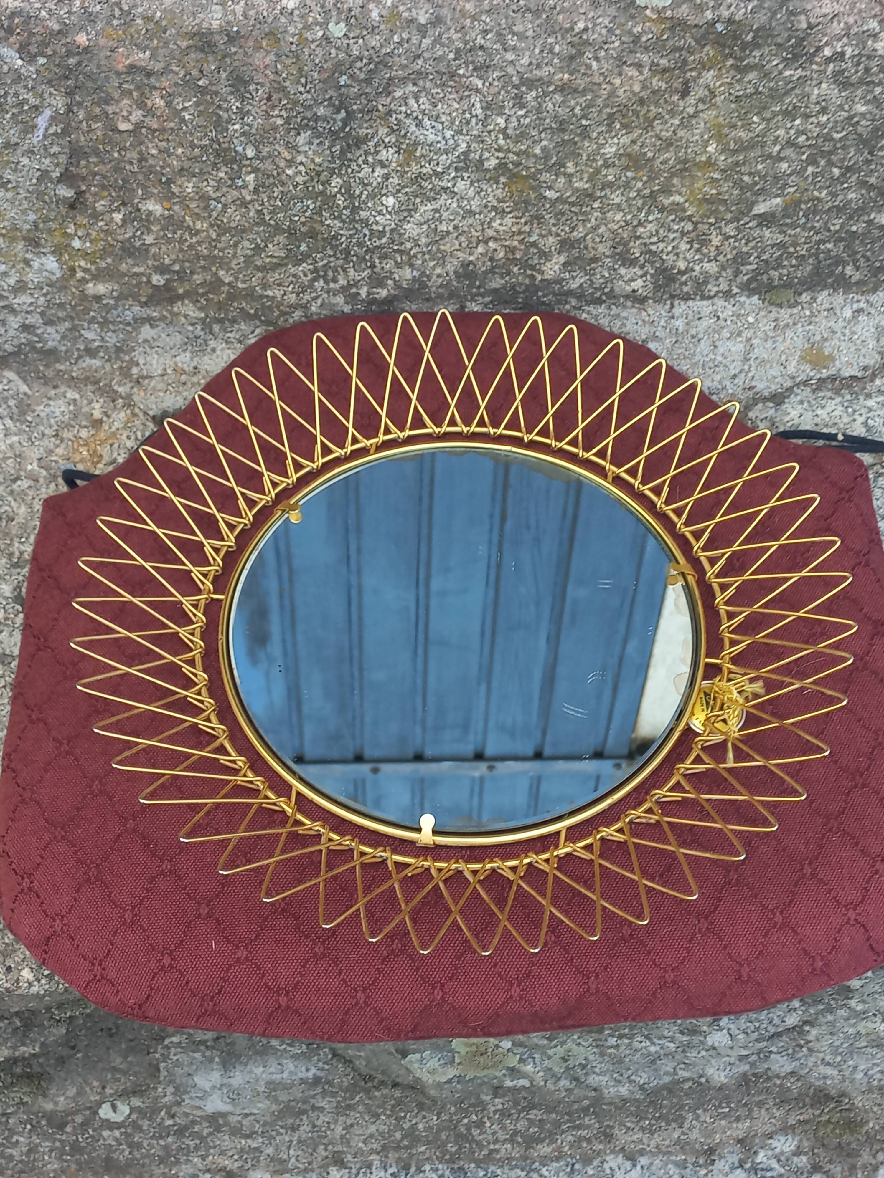 Vintage 1950s sun mirror in gold metal.