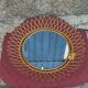 Vintage 1950s sun mirror in gold metal.