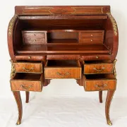 Louis XV cylinder desk with floral marquetry and gilded ornaments.