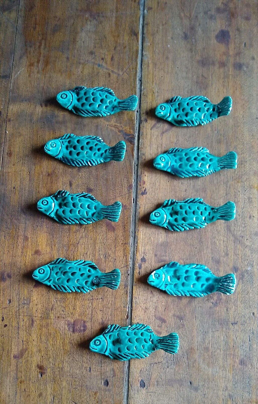 9 knife holders in green earthenware in the shape of a fish