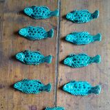 9 knife holders in green earthenware in the shape of a fish