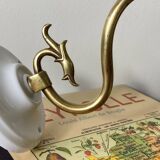 Swan neck wall light in brass with rose petal glass shade.