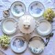 Antique mismatched earthenware soup plates with a tureen