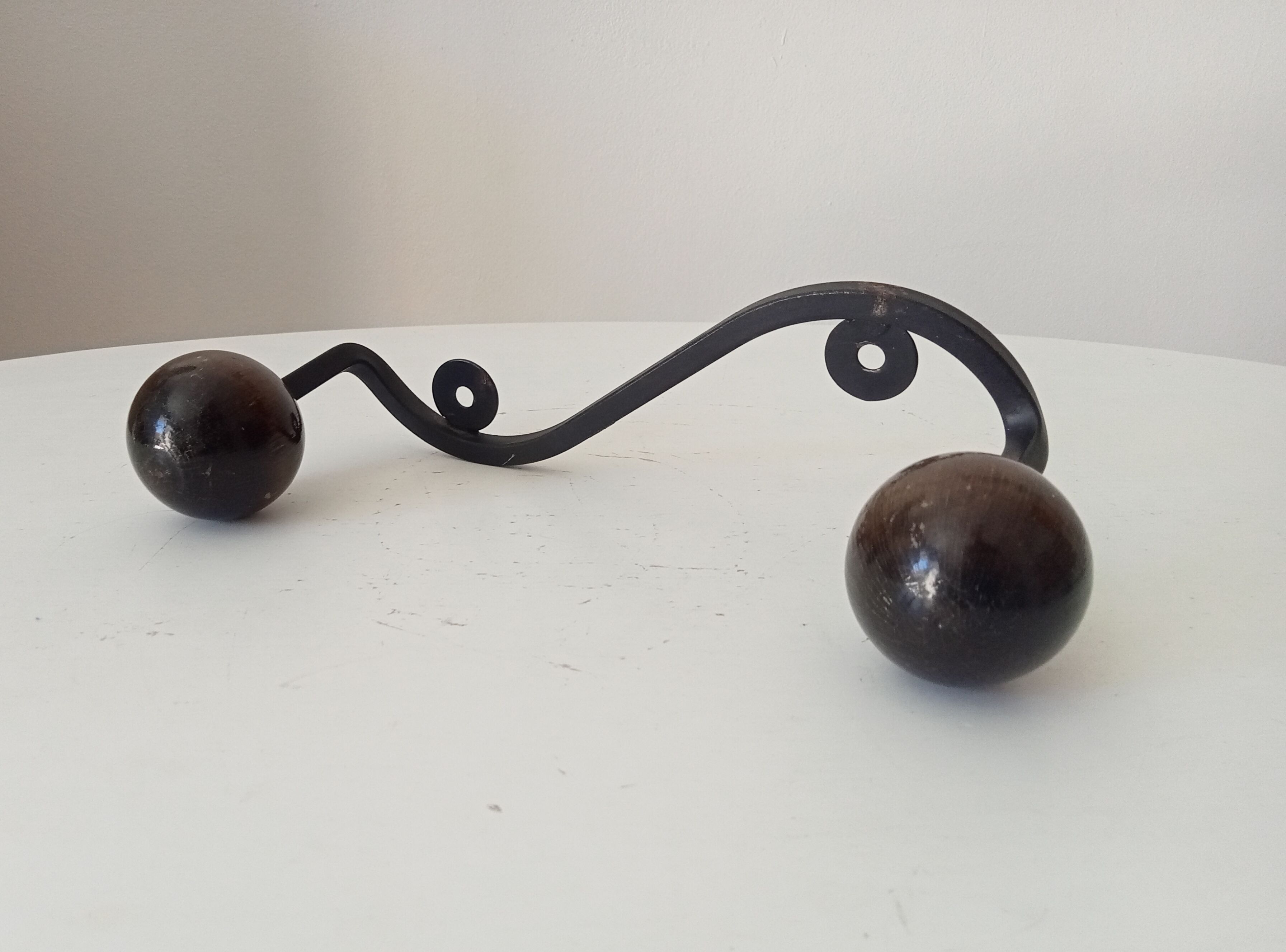 Wood and wrought iron ball coat rack from the 1950s.