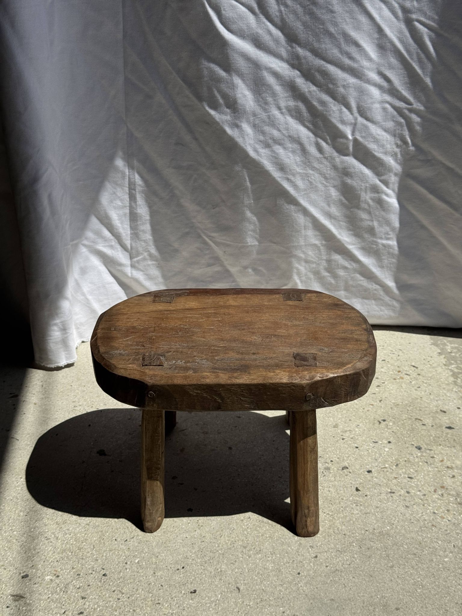 Small stool, oval solid teak accent stool with a two-tone seat.
