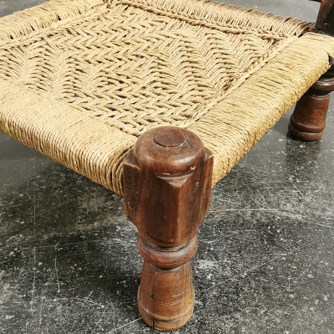 Ancient ethnic chair made of solid wood and rope