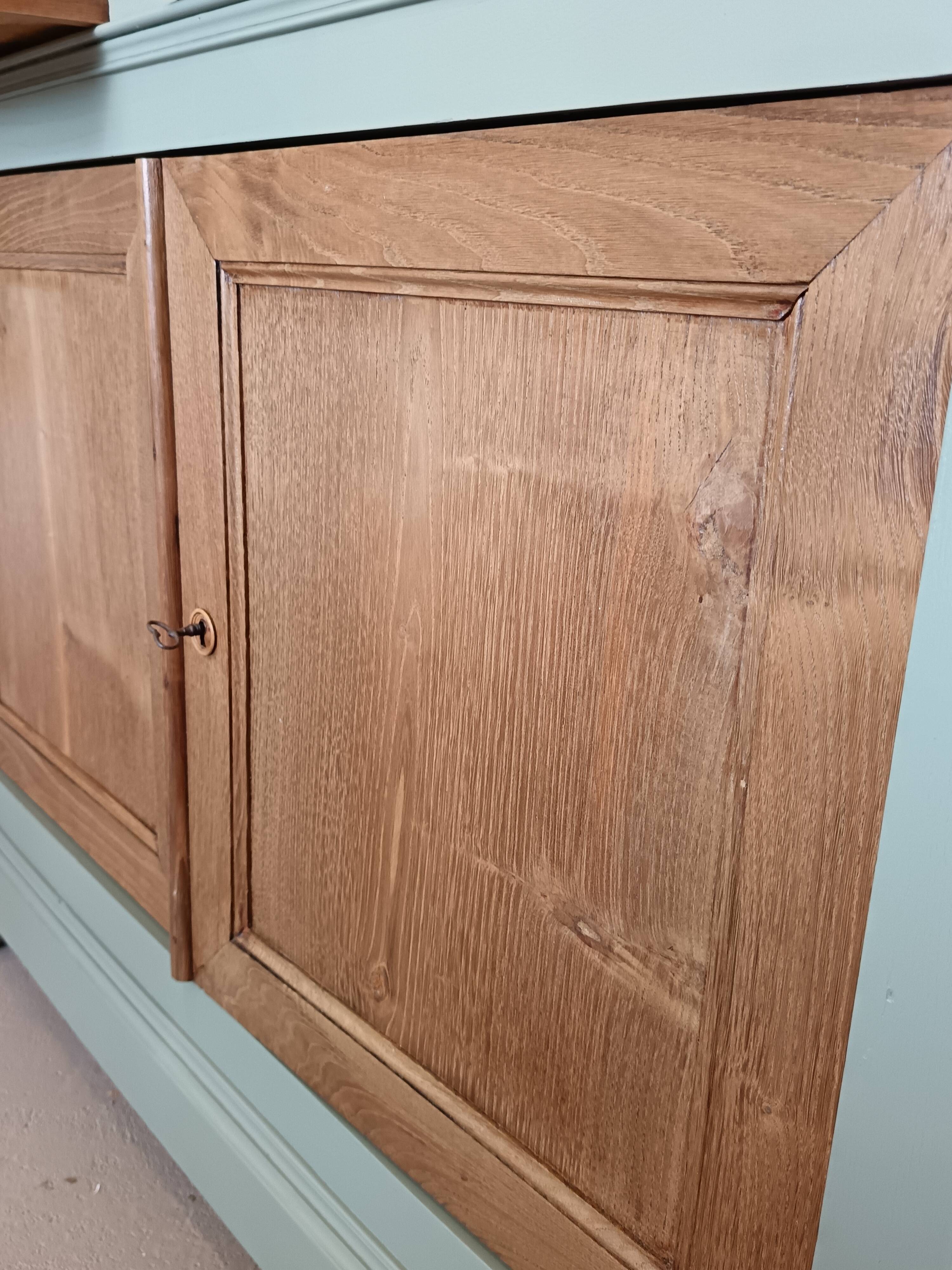 Buffet made of natural wood and bronze green.