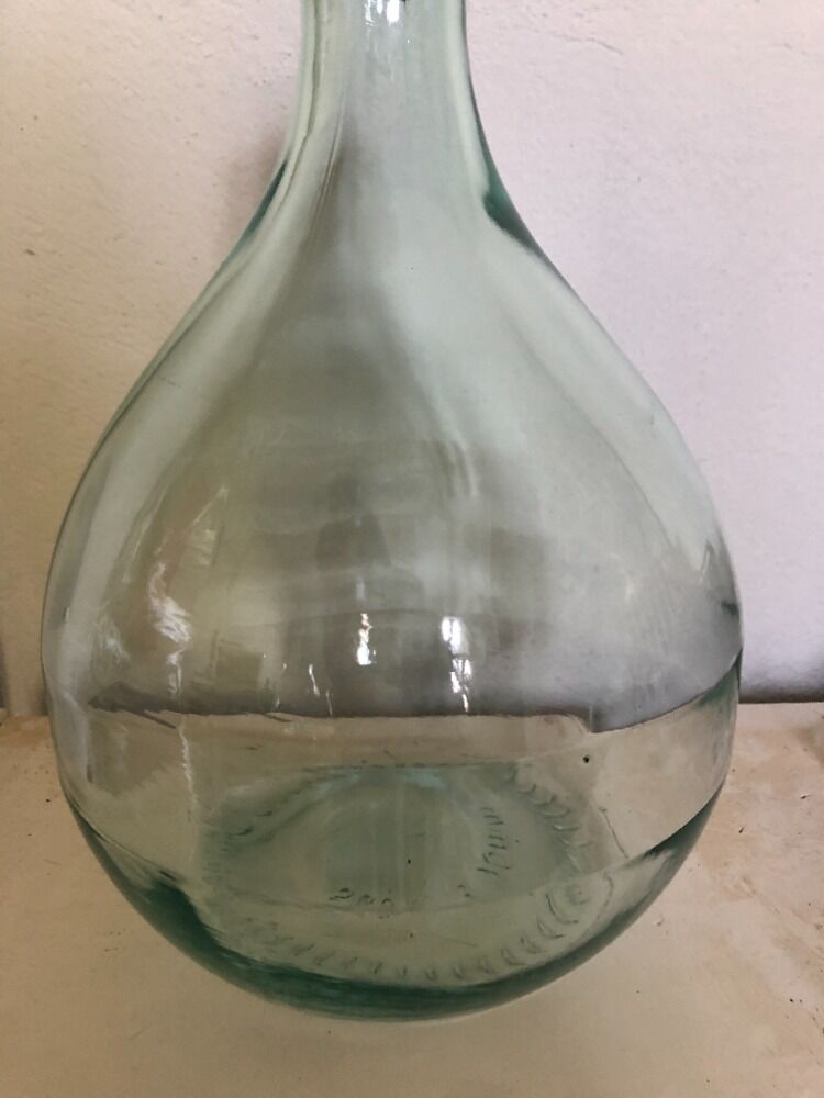 Demijohn in glass with light blue reflection