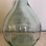 Demijohn in glass with light blue reflection