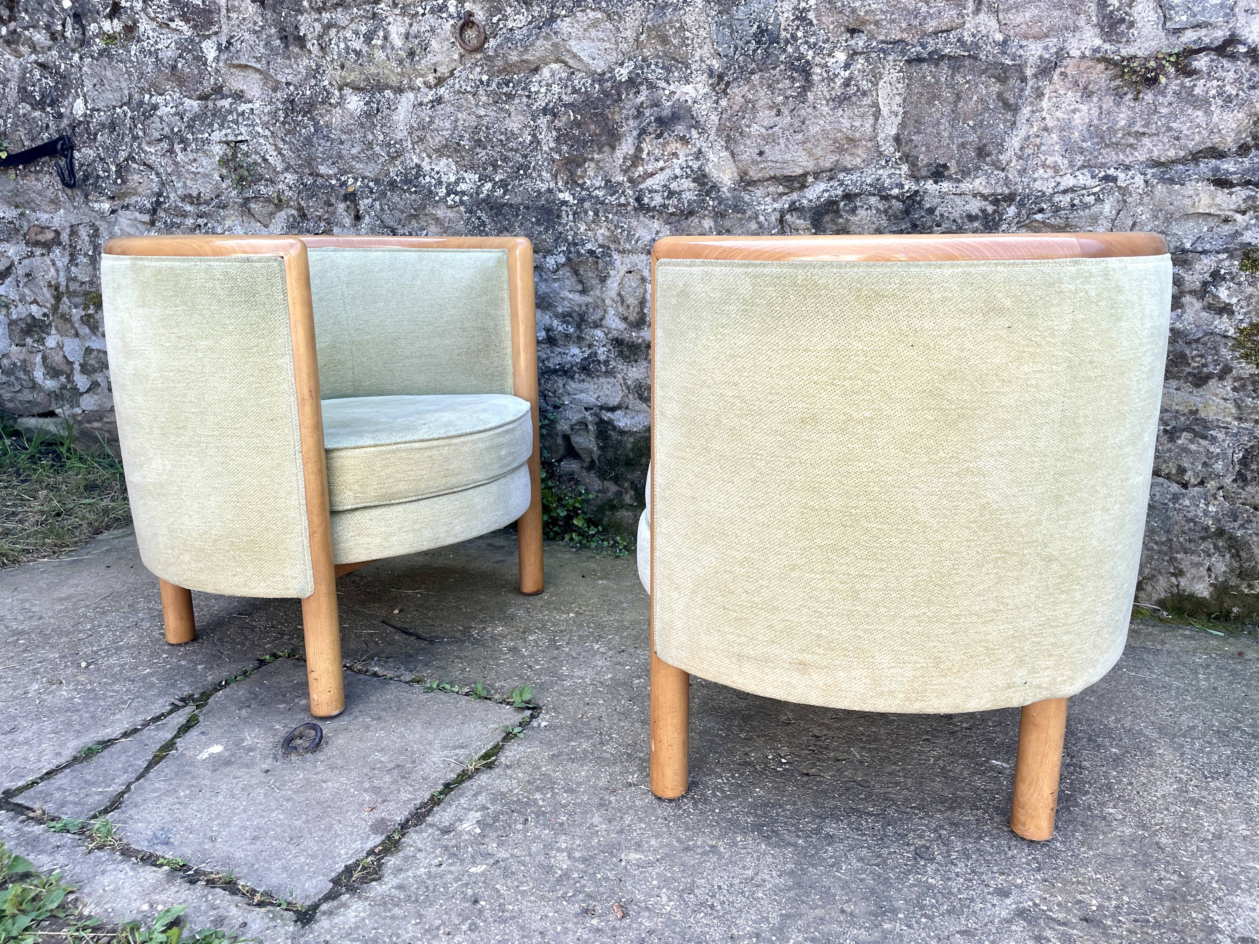 Pair of barrel-shaped armchairs in beech and almond green velvet by Maison Rosello