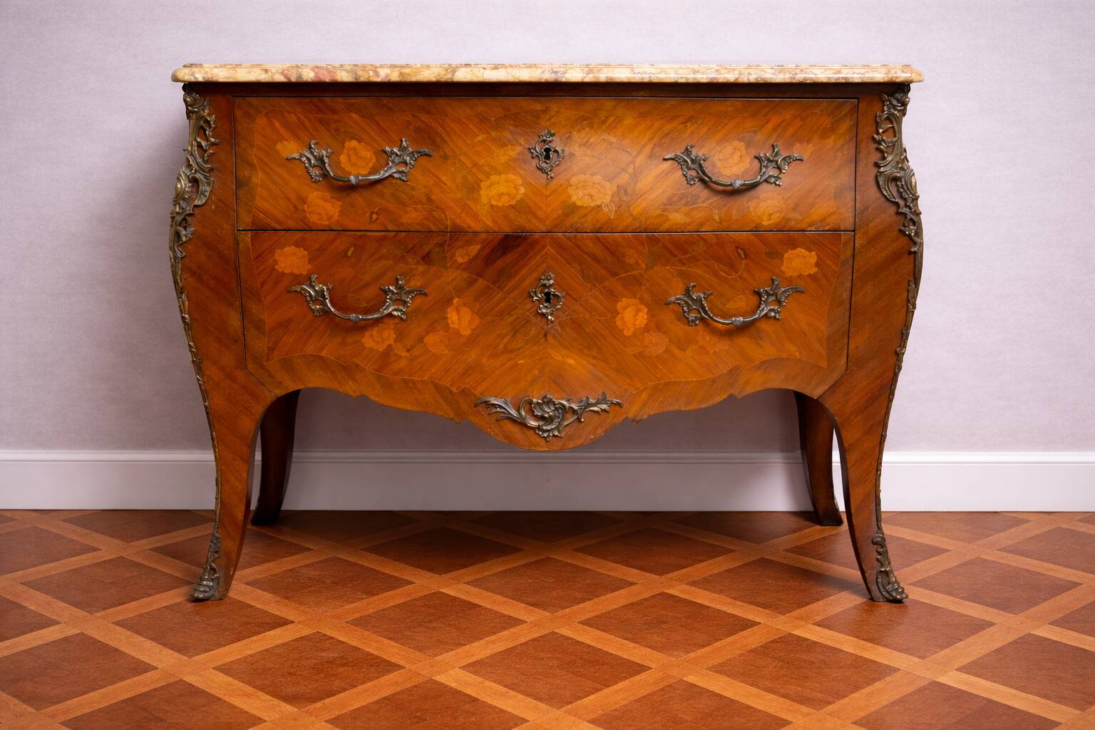 Curved Louis XV style commode with floral marquetry and marble top.