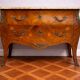 Curved Louis XV style commode with floral marquetry and marble top.
