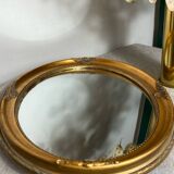 Oval-shaped gilded wooden mirror