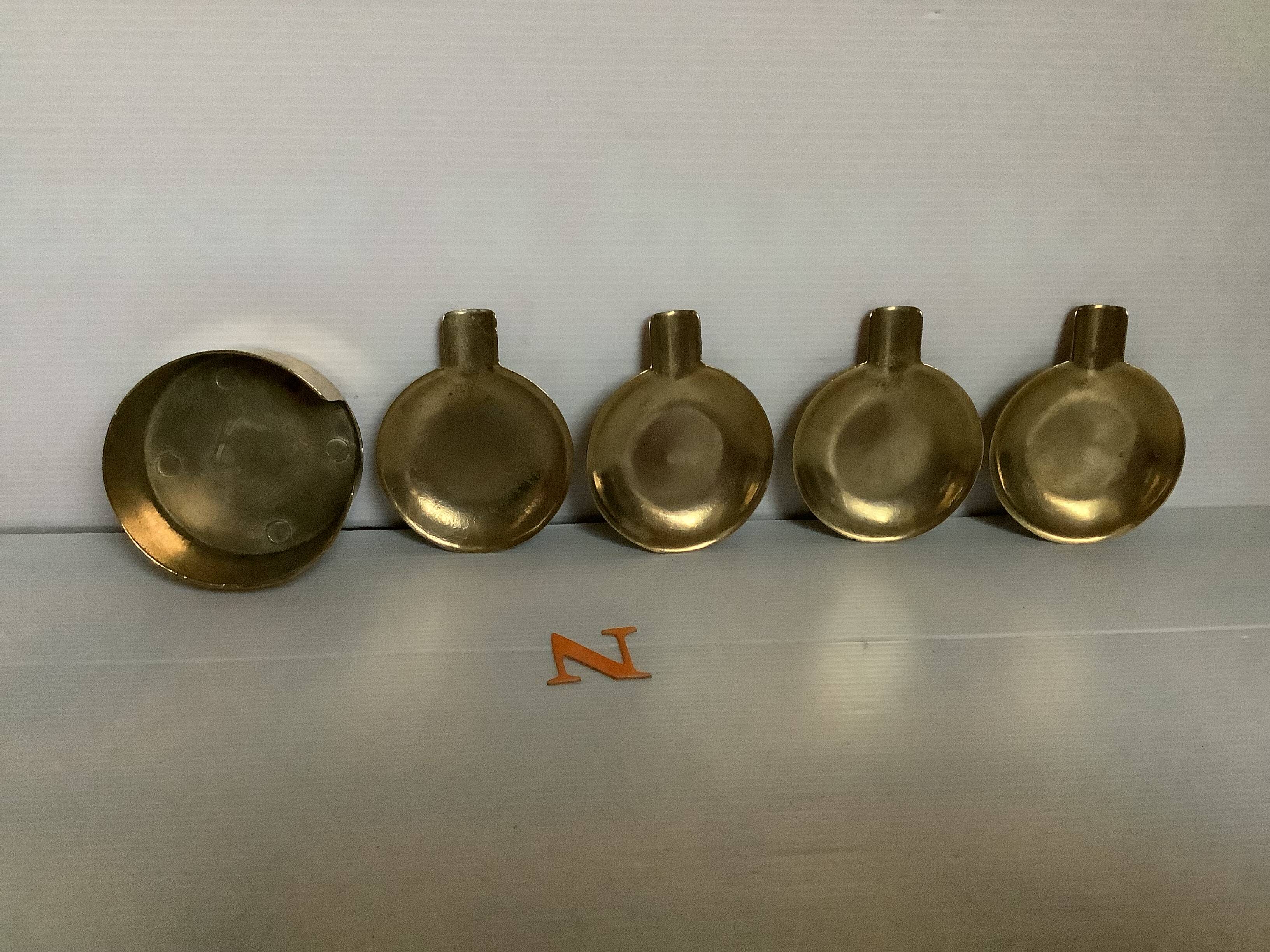 Four individual brass ashtrays