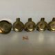 Four individual brass ashtrays