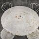Antique painted wrought iron garden furniture, round table and four chairs.