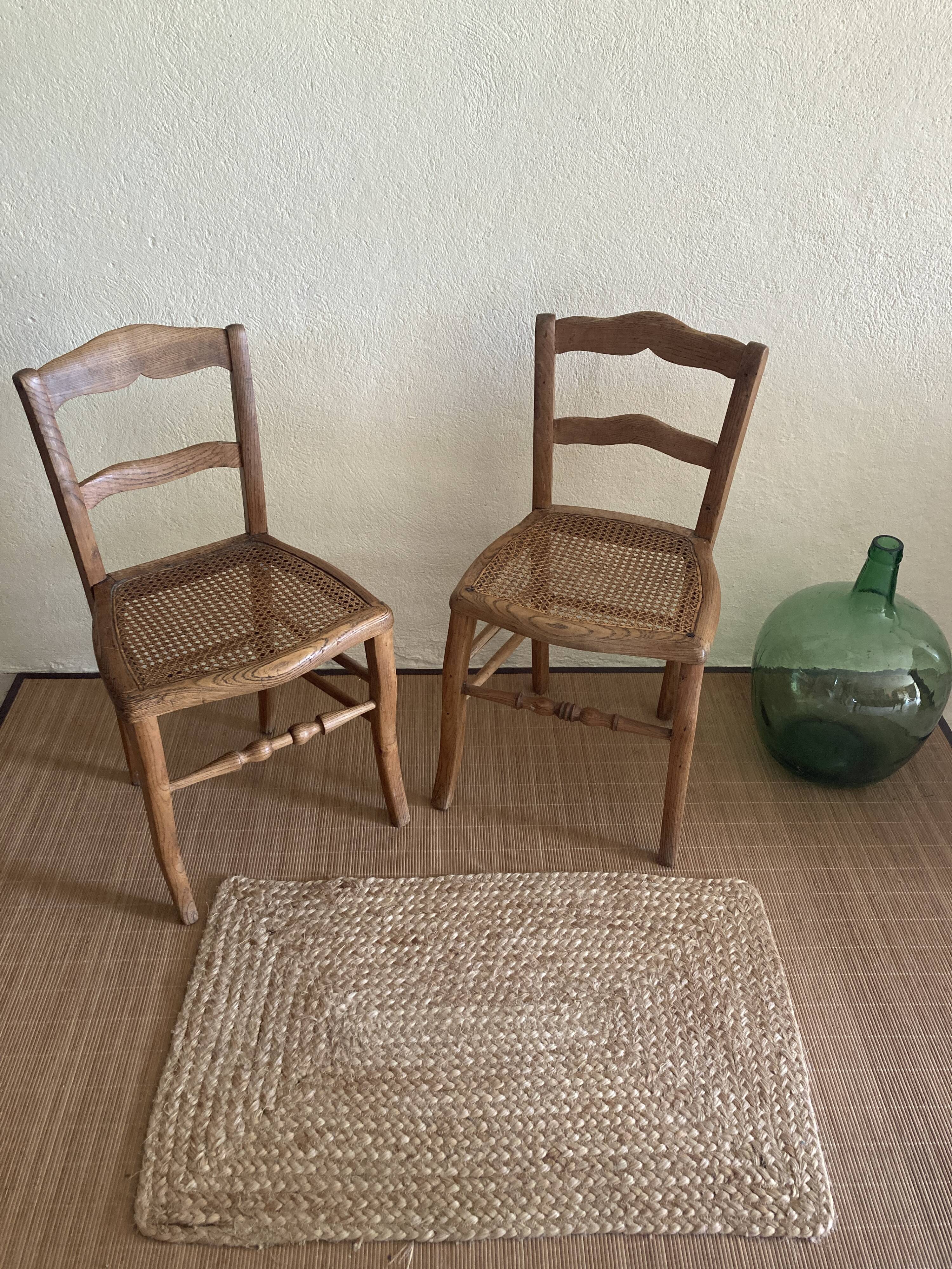 Set of two antique chairs with caning.