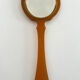 Chic coral orange hand mirror with a mother-of-pearl back – elegant retro style.
