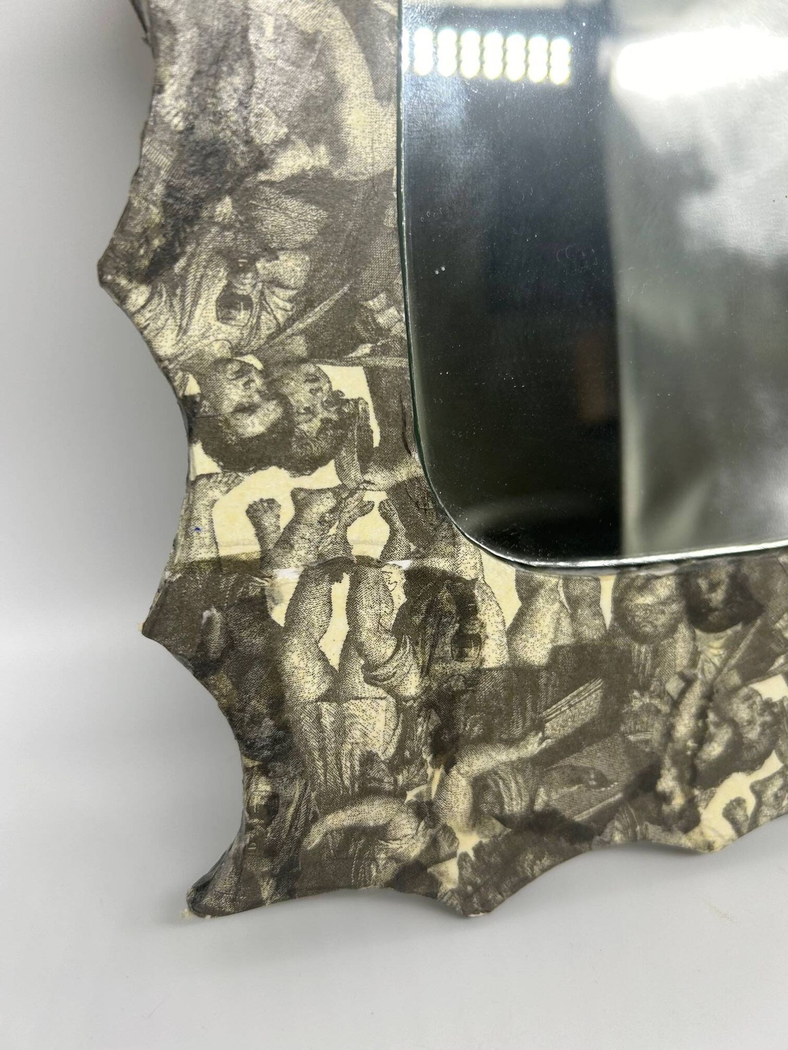 Free-form mirror decorated with cherubs.