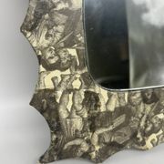 Free-form mirror decorated with cherubs.