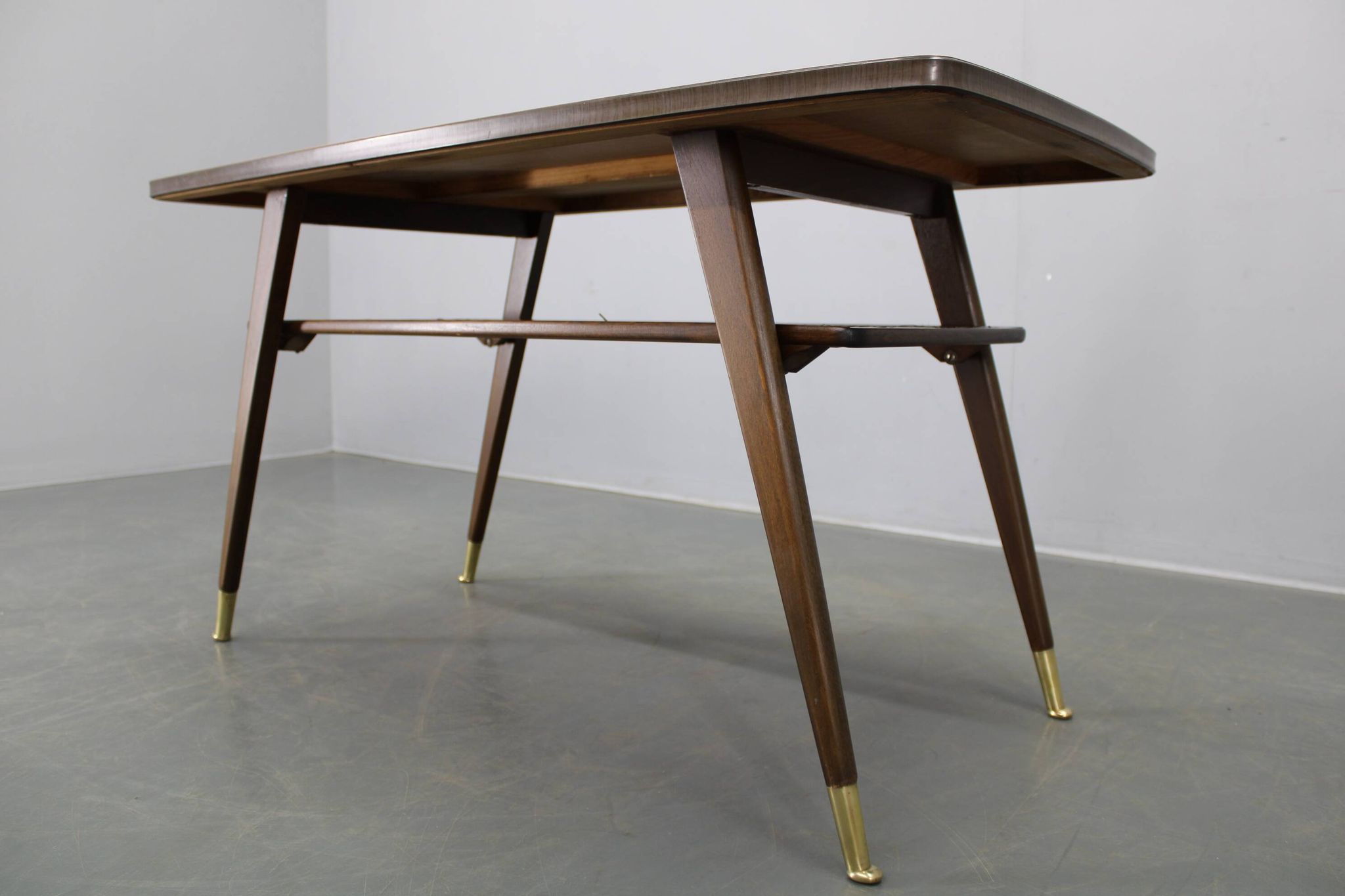 Mid-century German coffee table with rattan shelf and brass legs