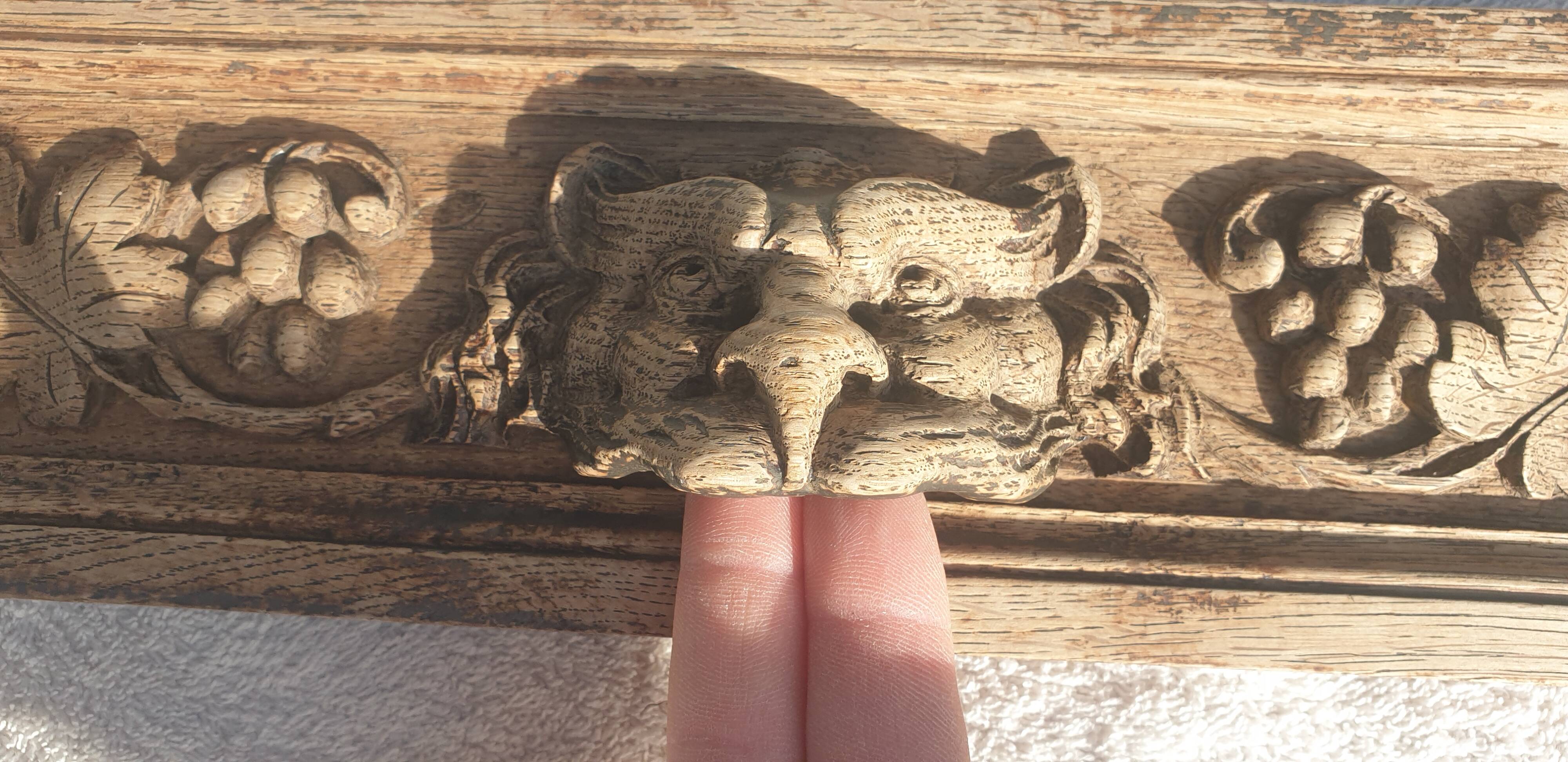 Carved wooden pediment with bunches of grapes