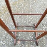 Valet wearing double wood coat rack