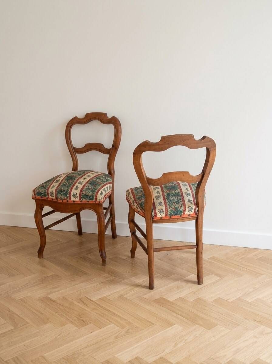 Pair of antique Louis XV style chairs in wood and floral fabric.