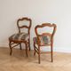 Pair of antique Louis XV style chairs in wood and floral fabric.