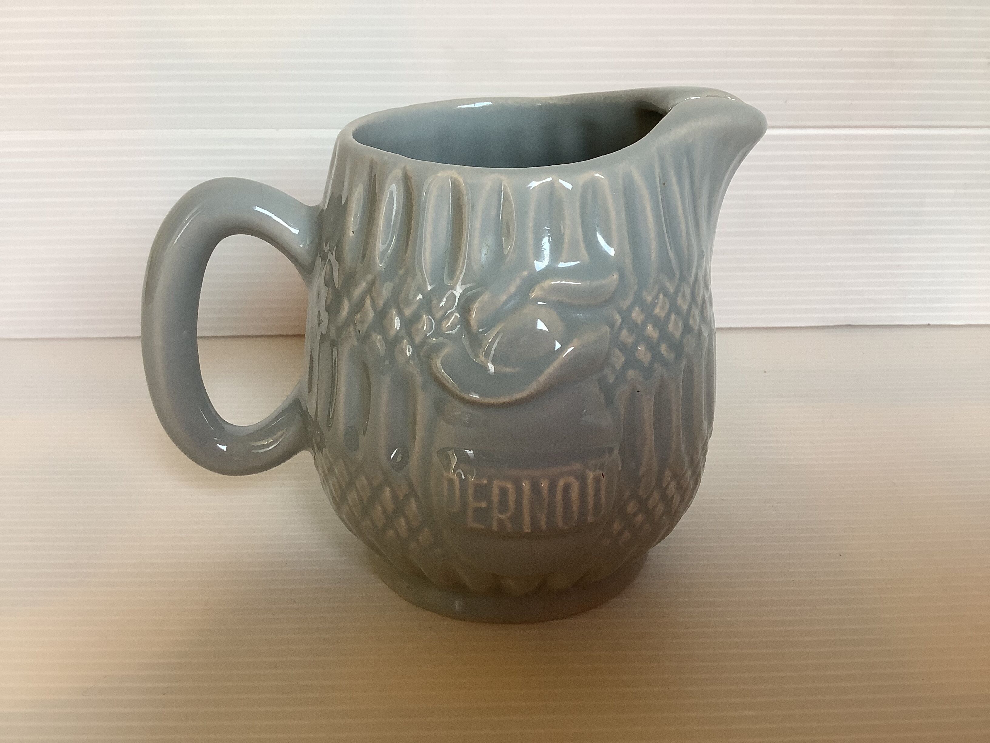 Old grey earthenware Pernod jug