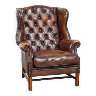 Luxurious, stately brown leather chesterfield armchair finished with decorative nails