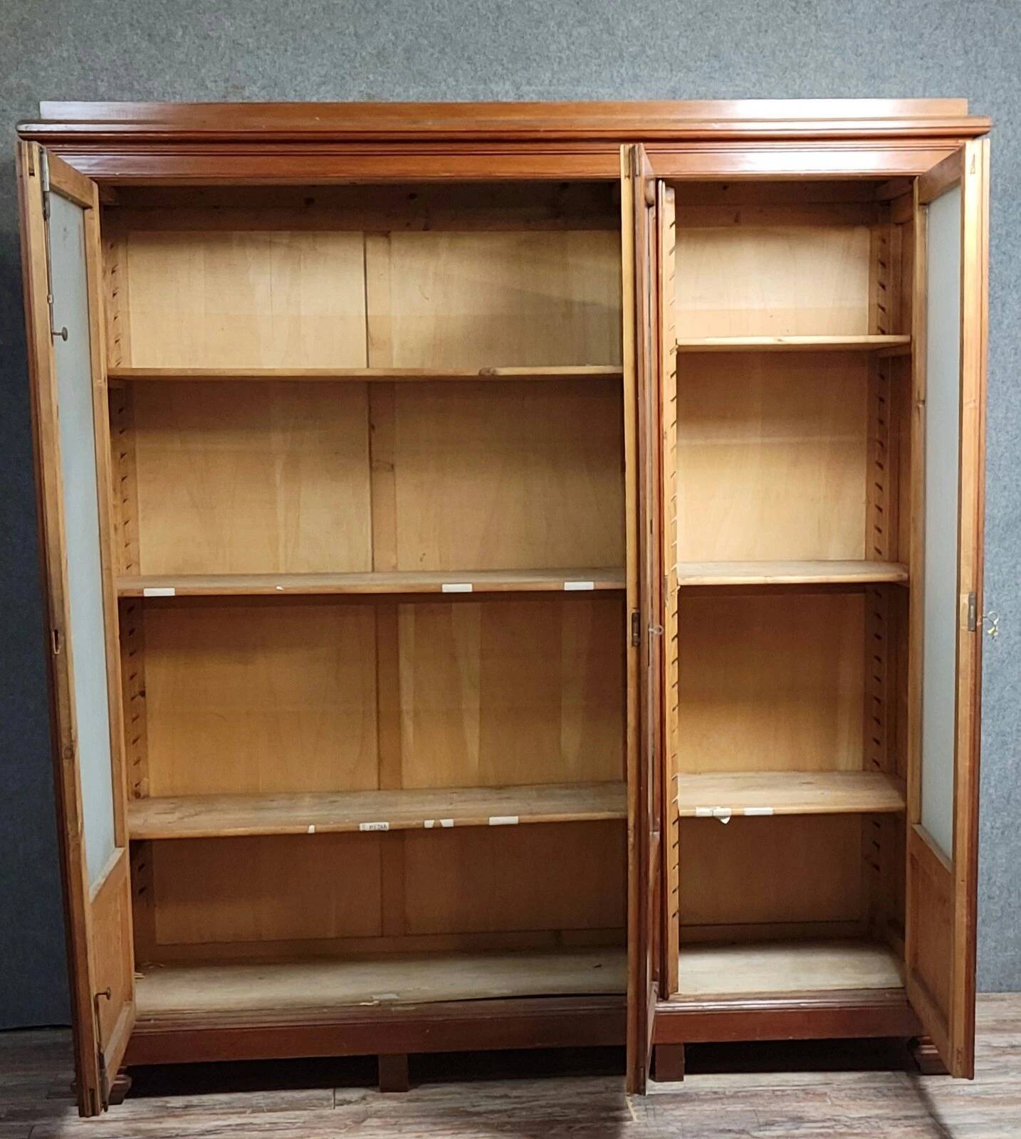 Large pine bookcase with three doors, fitted with frosted glass.