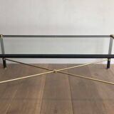 Brass coffee table upholstered in black leather. In the style of Jacques Adnet.