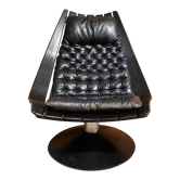 Hans Brattrud lounge chair in thermoformed black wood and leather seat. Swedish work of