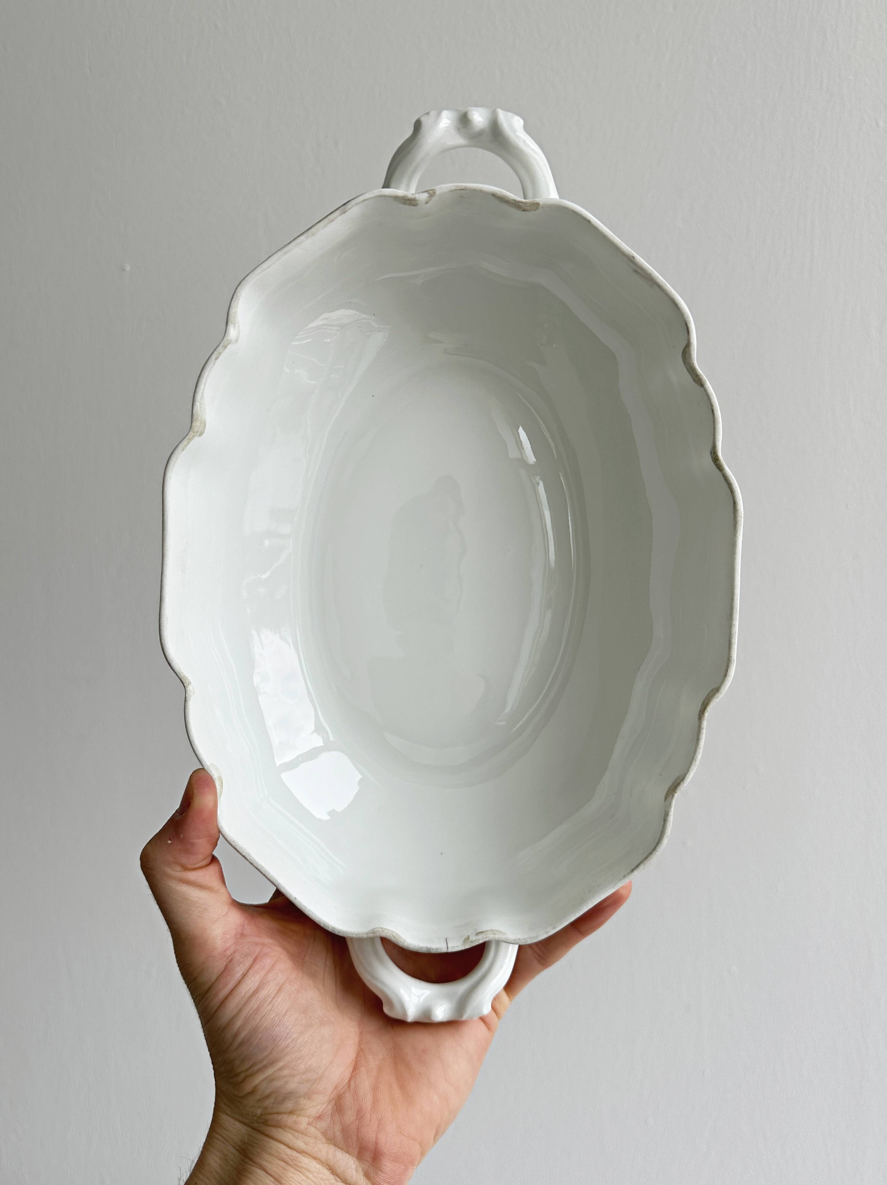 White fine porcelain soup tureen with relief decoration.