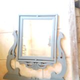 Rocking patinated wood mirror