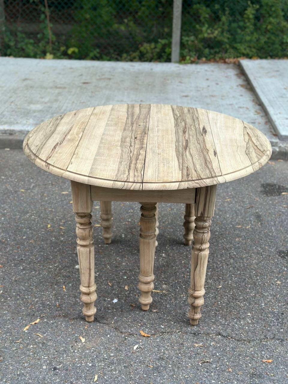 Round extendable dining table with flaps, stripped in raw oak, with 4 extensions.
