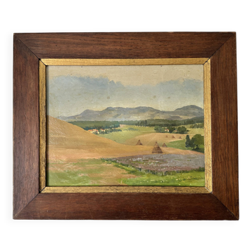 Old oil painting of a landscape on panel from 1920, haystacks.