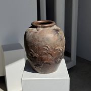 Large traditional Indonesian clay pot featuring a dragon.