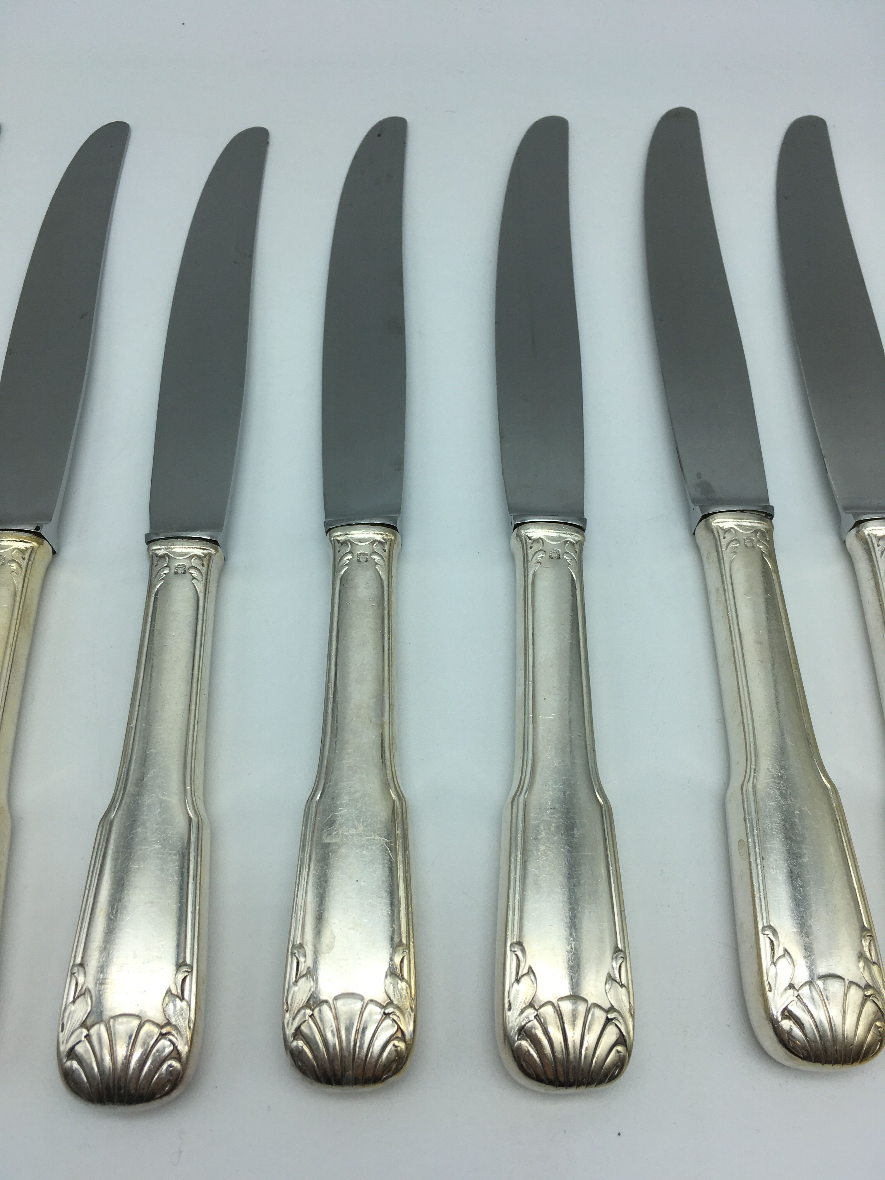 12 silver metal knives.