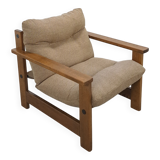 Brown-grey armchair with an oak frame.
