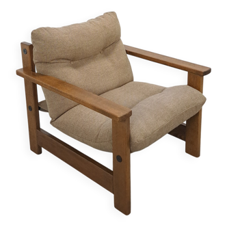 Brown-grey armchair with an oak frame.