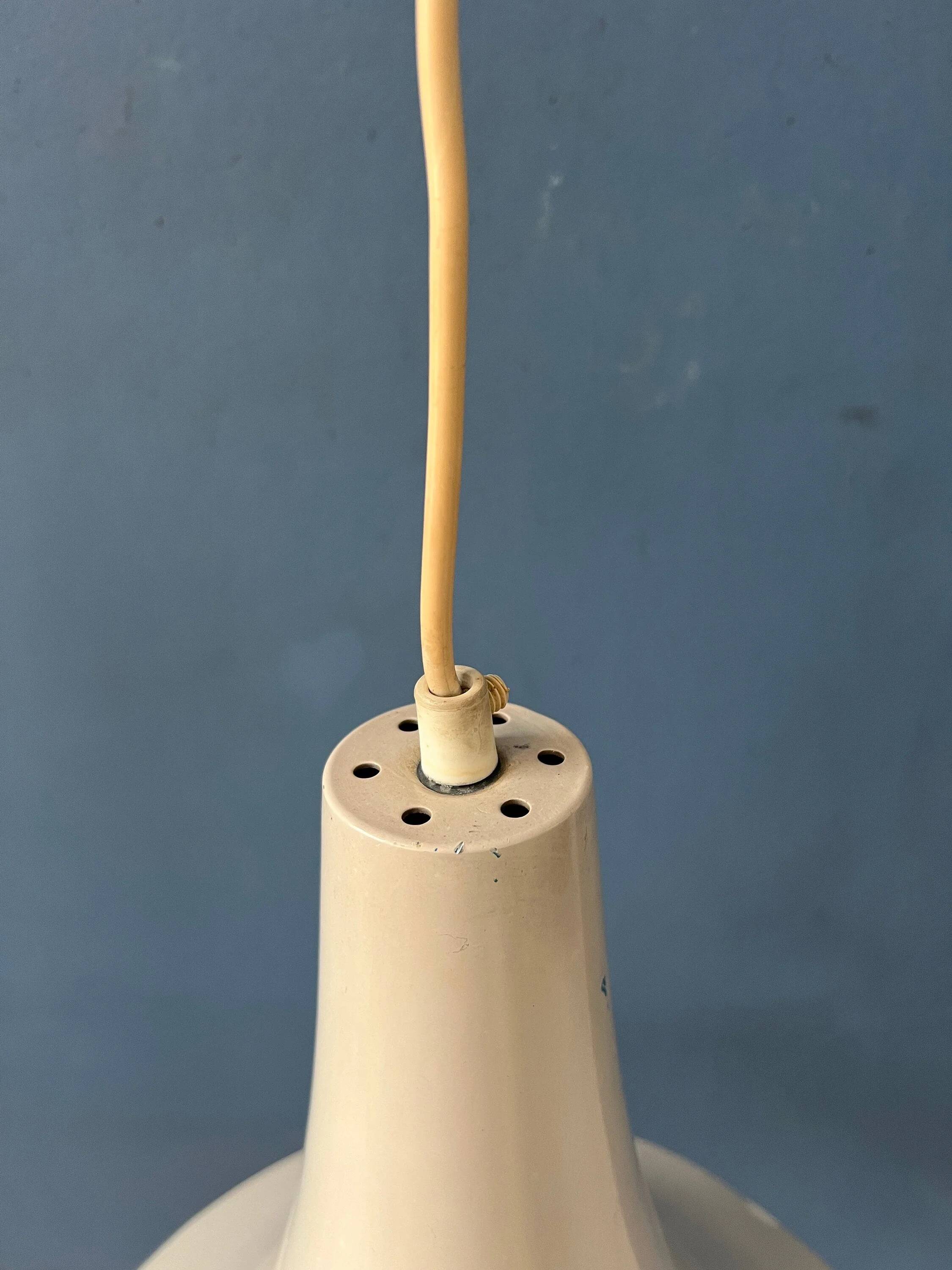 Small vintage beige pendant light in the shape of a witch's hat.