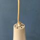 Small vintage beige pendant light in the shape of a witch's hat.