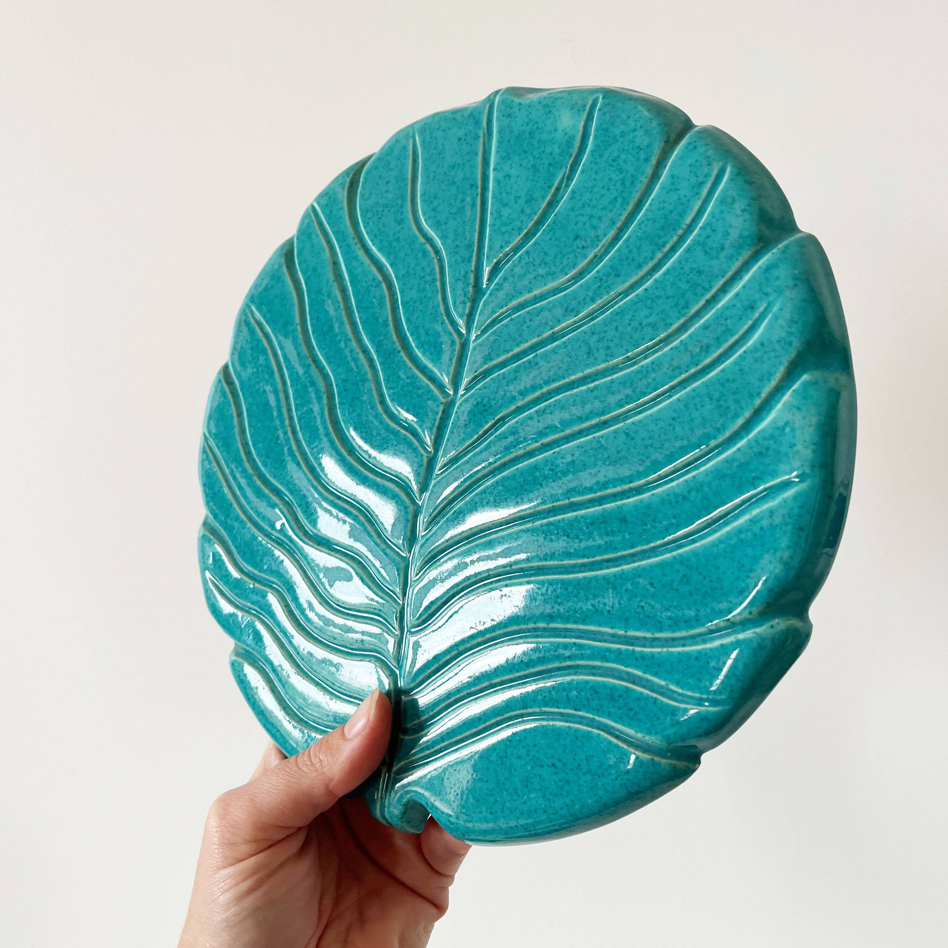 Ceramic trivet and bottle coaster from the 1950s.