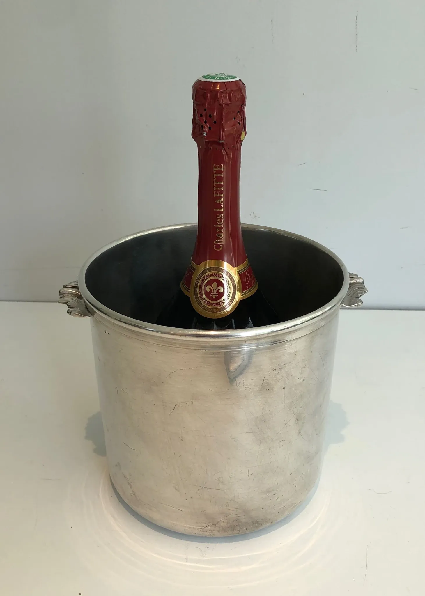 Cylindrical Silver-Plated Champagne Bucket with Small Leaf-Shaped Handles.