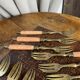 Dessert forks in brass and Bakelite in their case.