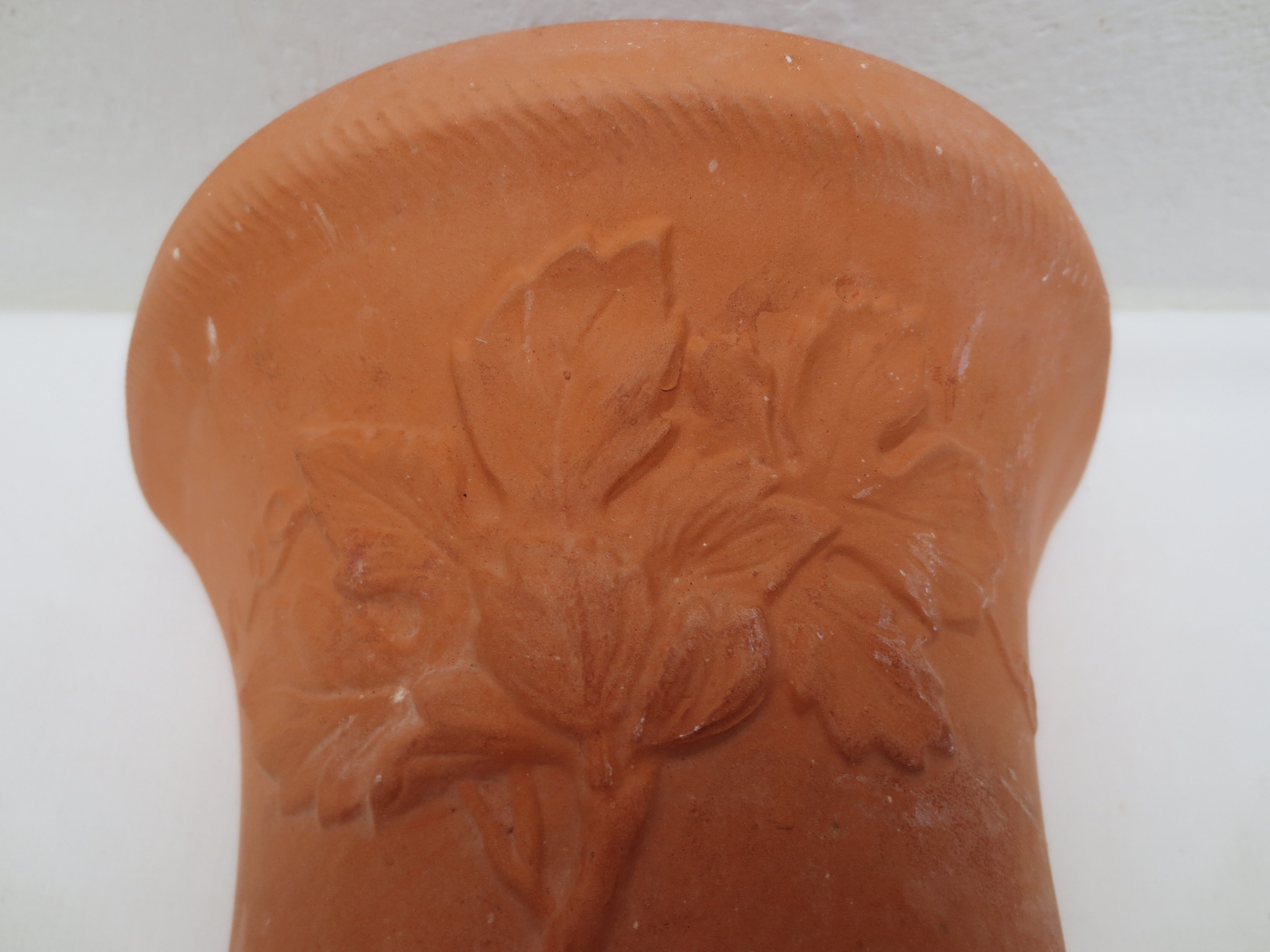Duo of decorated terracotta wall flowerpots