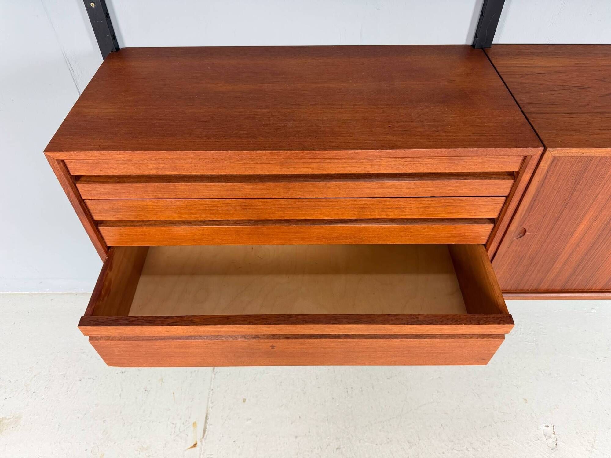 Modular wall shelf in teak in mid-century modern style, designed by Poul Cadovius for Cado, 1960.